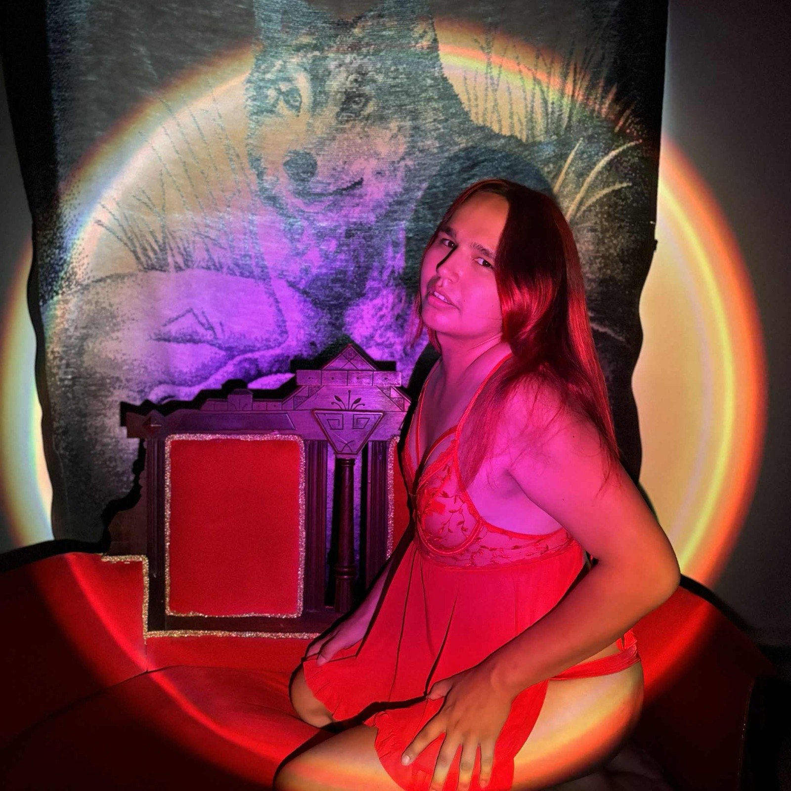 9a in a red lace dress on the throne in front of the wolf blanket